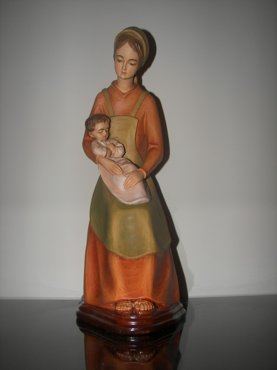 figurative sculpture of a woman holding a child