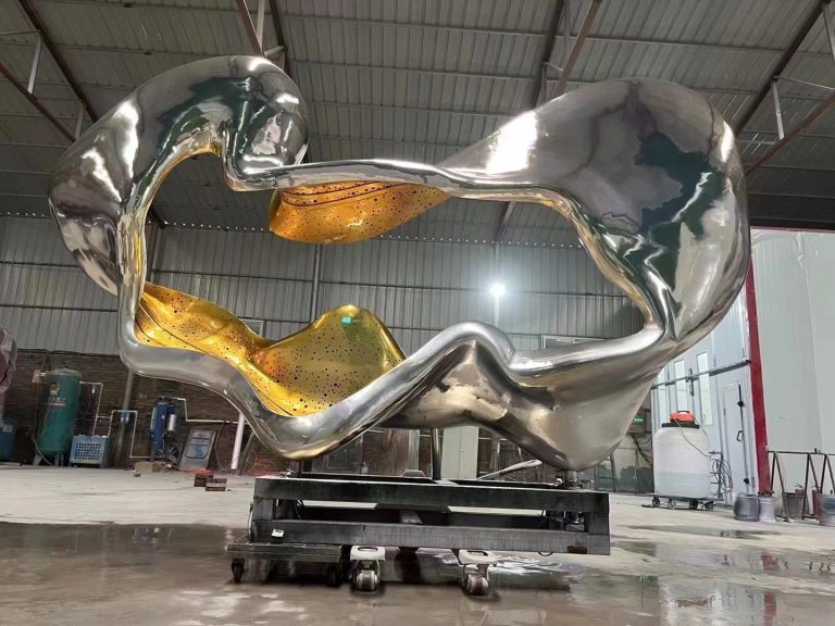 abstract sculpture with polished metal and golden interior