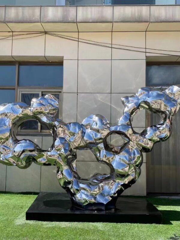 abstract sculpture with fluid shapes and reflective surfaces