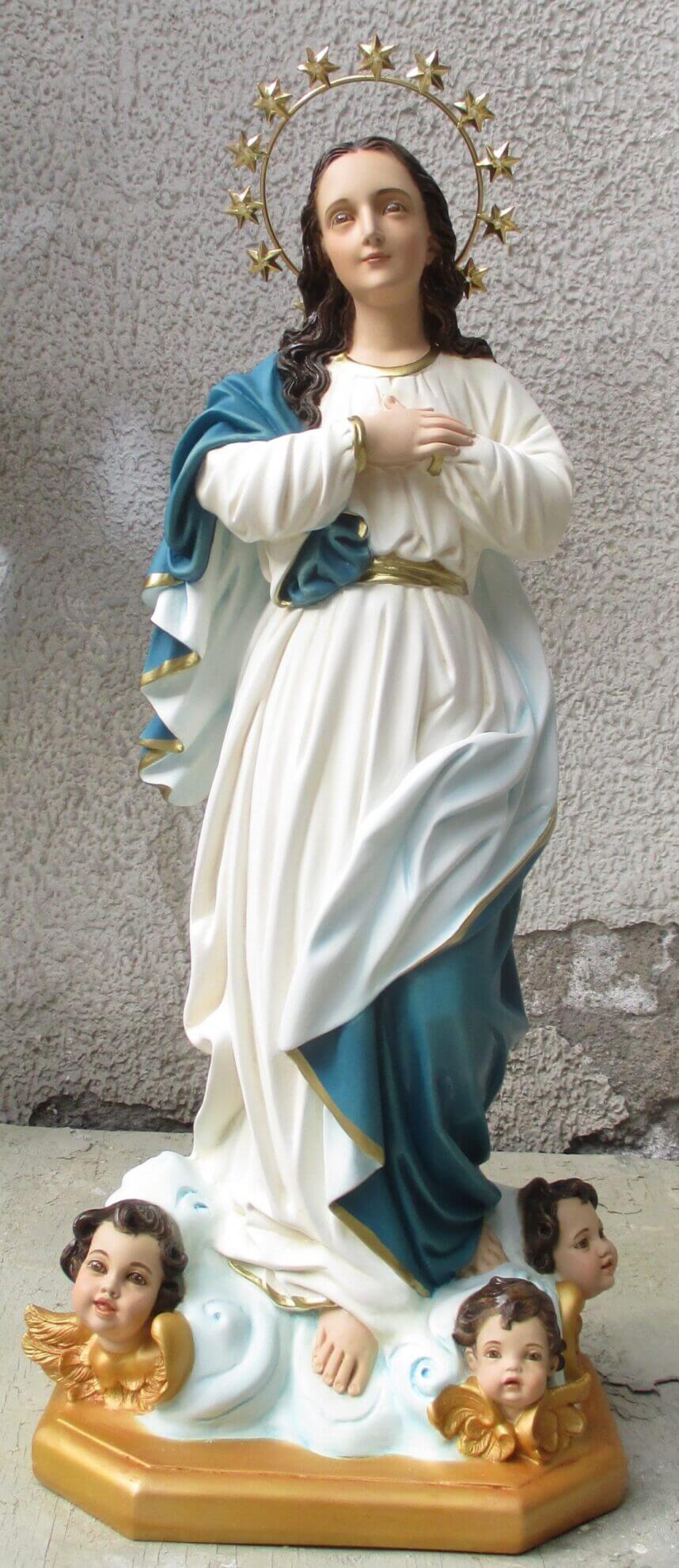 figurine of a woman in a flowing robe with cherubs