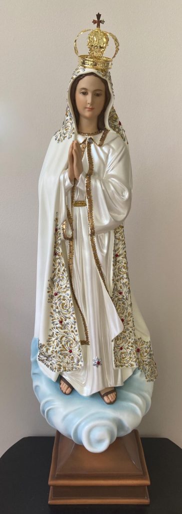 figurative sculpture of a crowned woman in white robes