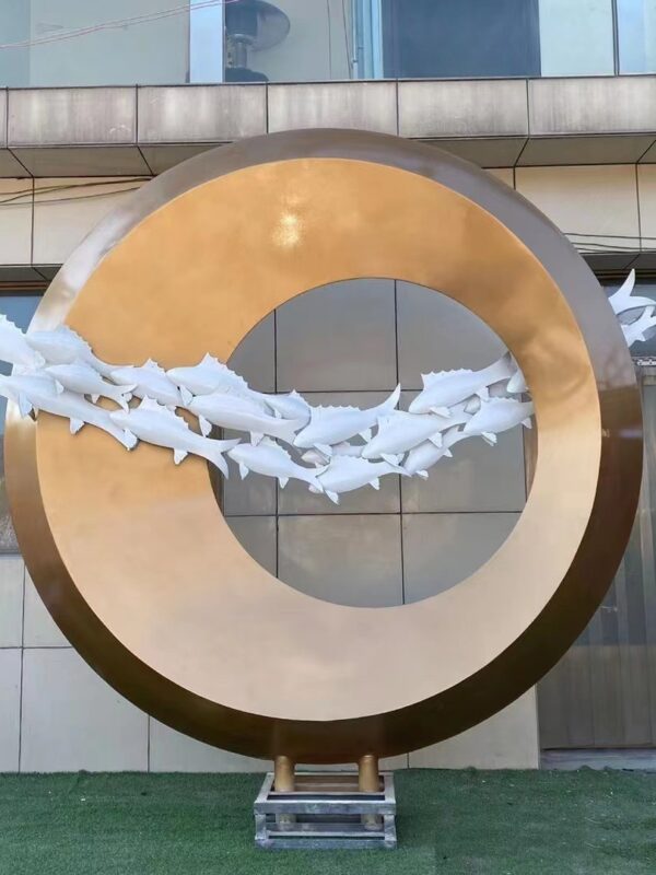 Abstract fish sculpture in a circular gold frame