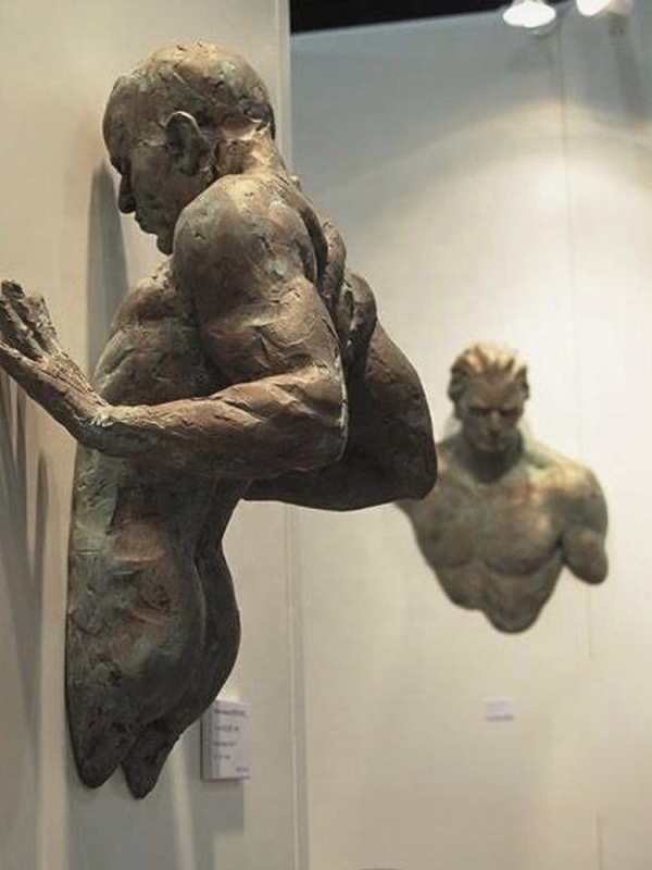 Contemplative Man on Wall Sculpture