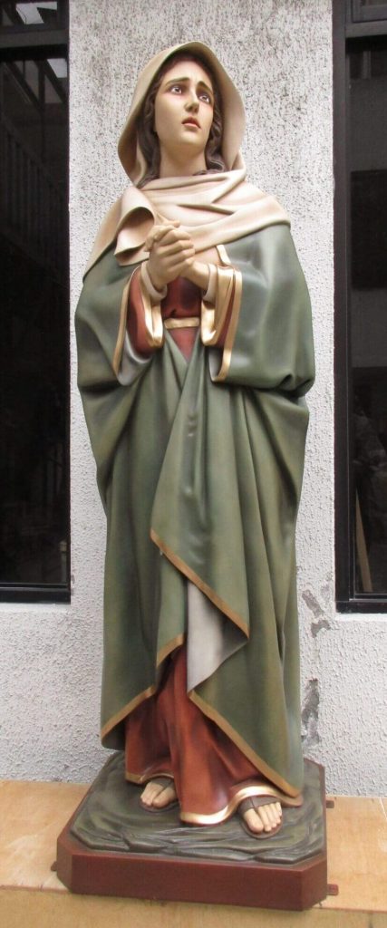 figurative statue of a woman in a green robe
