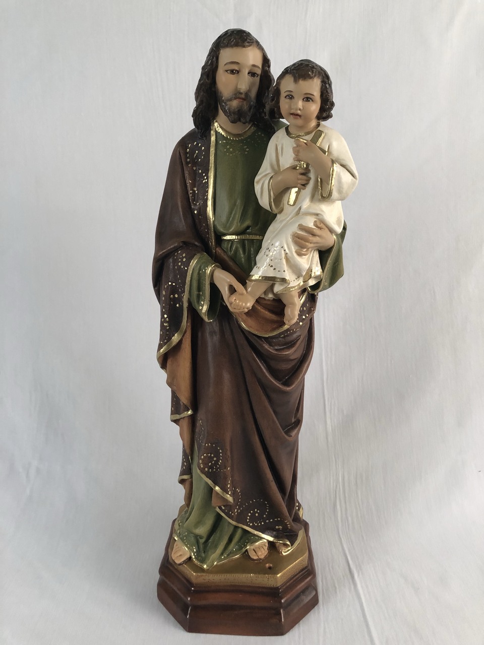religious sculpture of a man holding a child