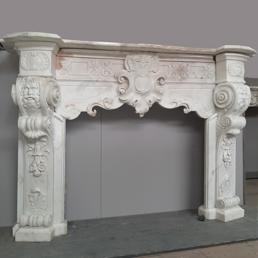 ornate white marble fireplace mantel with intricate carvings