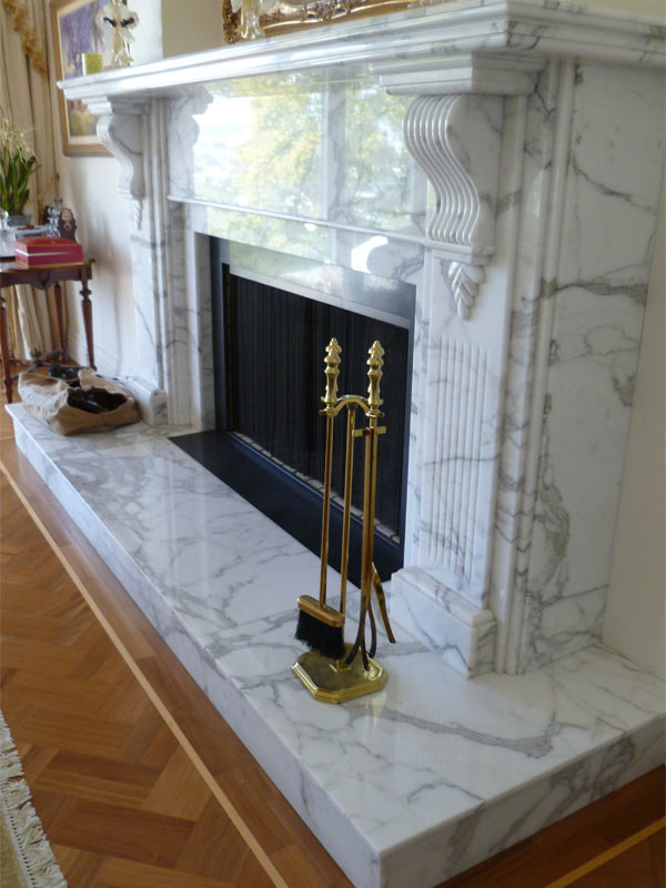 elegant marble fireplace with decorative mantel and tools